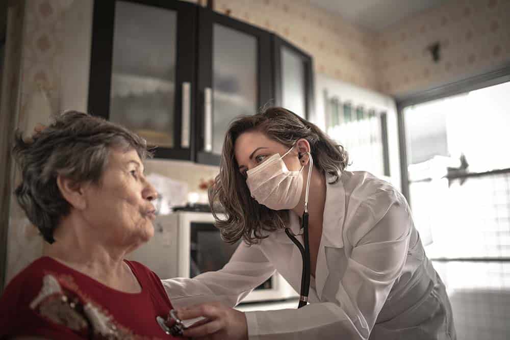 Health visitor and a senior woman during home visit