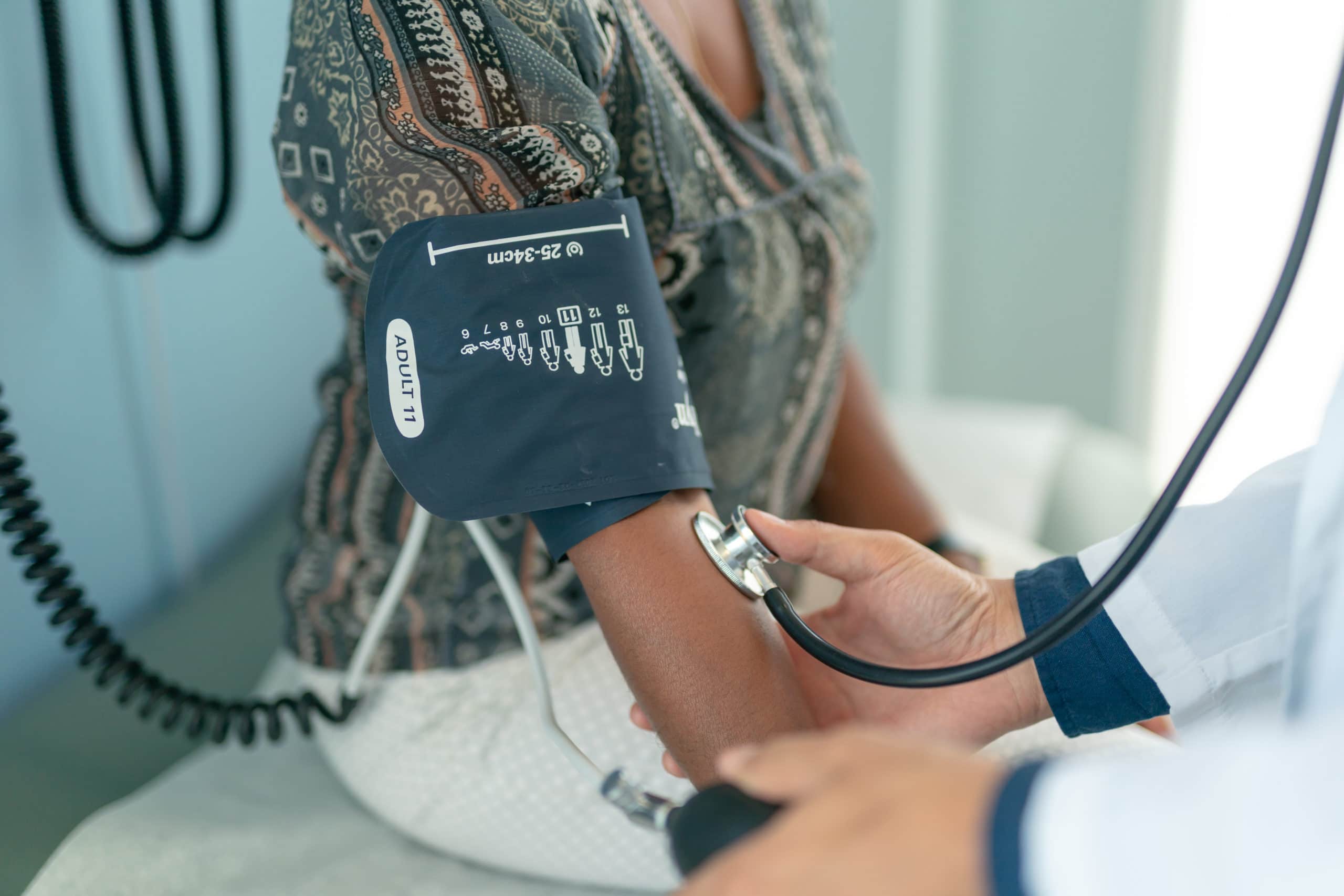 Mature adult woman has blood pressure checked